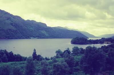 A wooded shore and island on Loch Lomond — Scottish Highlands, Scotland (late July 2000)