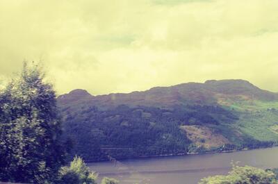 Forested ridges above the still water of Loch Lomond — Scottish Highlands, Scotland (late July 2000)