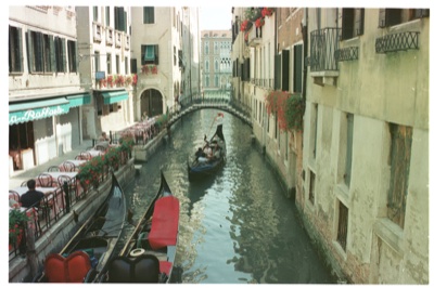 A gondolier passing the Trattoria da Raffaele terrace — Venice, Italy (7-10 June 2000)